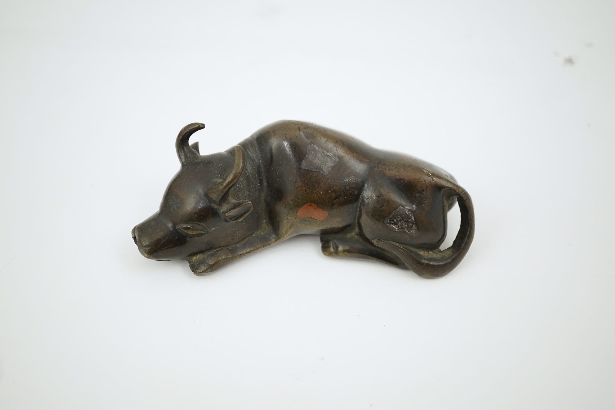 A Chinese bronze and mixed metal buffalo scroll weight, 19th century